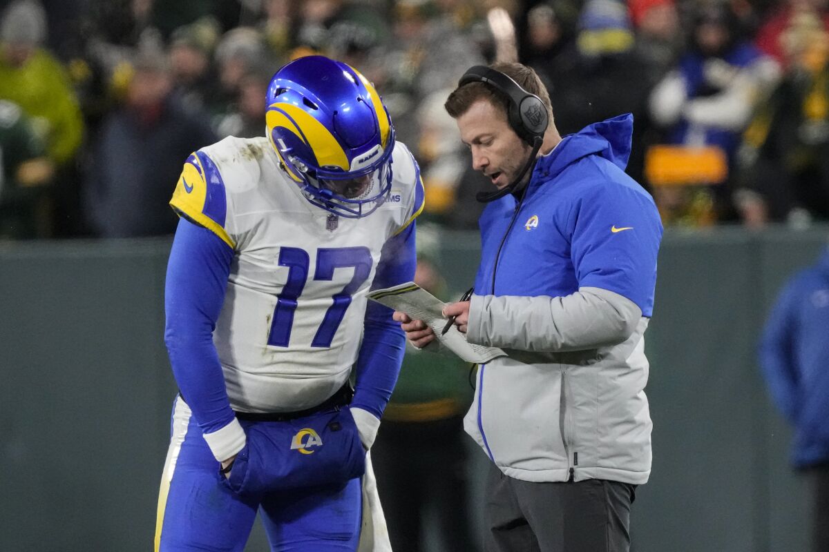 Quarterback Baker Mayfield (17) confers with Rams coach Sean McVay. 