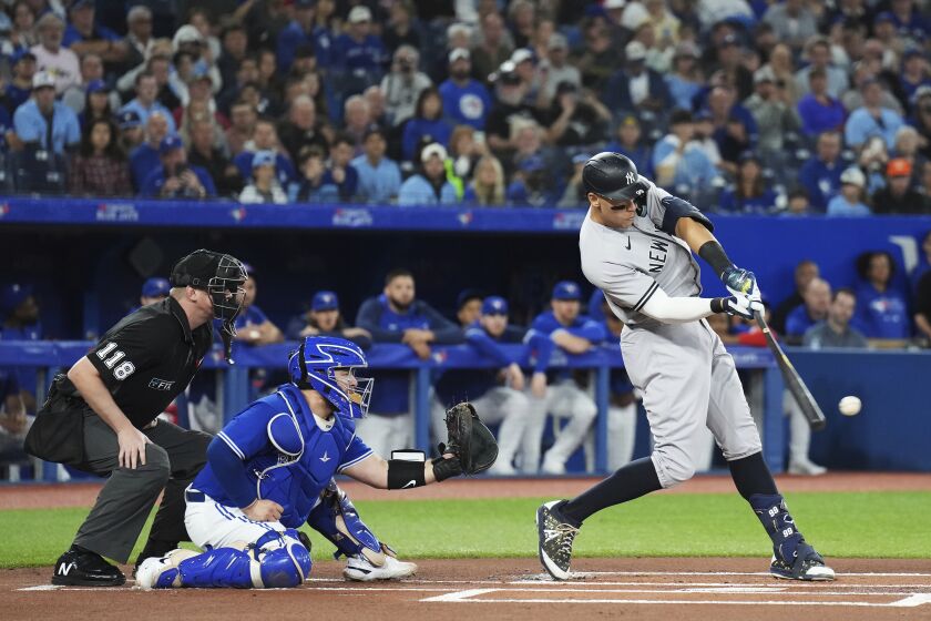 New York Yankees' Aaron Judge lines out to third as Toronto Blue Jays catcher Alejandro Kirk watches during the first inning of a baseball game Tuesday, Sept. 27, 2022, in Toronto. (Nathan Denette/The Canadian Press via AP)