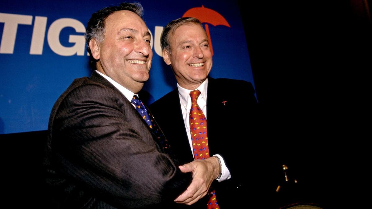 Sanford Weill, left, chief executive of Travelers Insurance, and John S. Reed, CEO of Citibank, announce the merger of their companies in 1998. (James Leynse / Corbis via Getty Images)