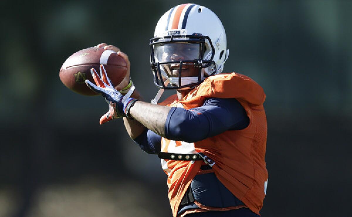 Auburn quarterback Nick Marshall takes part in a team practice session in Irvine on Thursday. Marshall has played a big role in transforming the Tigers into potential BCS champions.