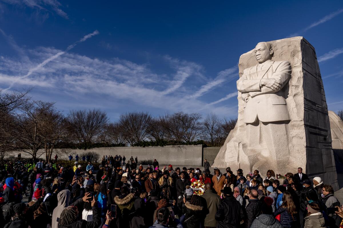 A large group gathers to watch a wreath-laying ceremony at the Martin Luther King Jr. Memorial in Washington