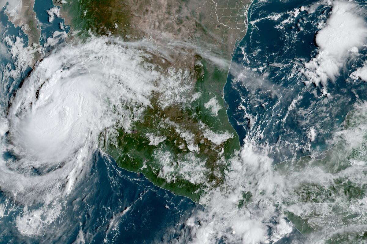 This satellite image provided by the National Oceanic and Atmospheric Administration shows Hurricane Olaf on the Pacific coast of Mexico approaching the Los Cabos resort region at the tip of the Baja California Peninsula, Thursday, Sept. 9, 2021, at 14:30 OZ (10:30am a.m. ET). (NOAA/NESDIS/STAR GOES via AP)