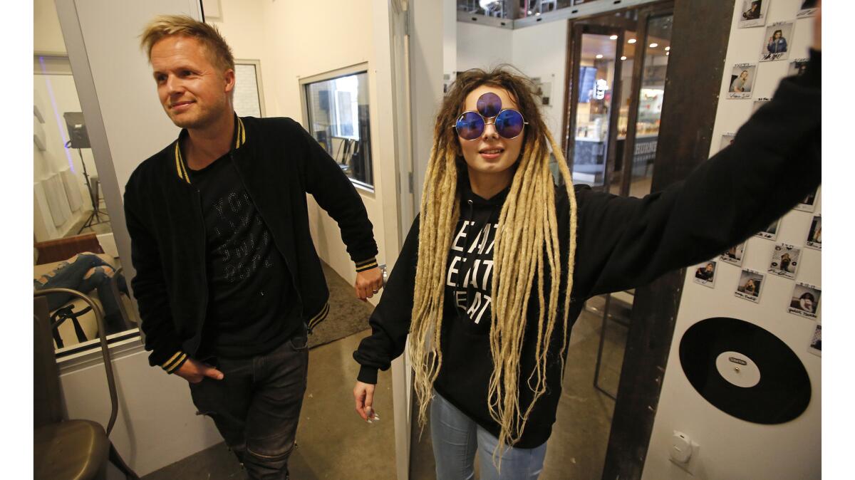 Thomas Barsoe, owner and founder of the OC Hit Factory recording and rehearsal studio, with Zhavia, one of the stars who got her start at his studio at The District in Tustin.