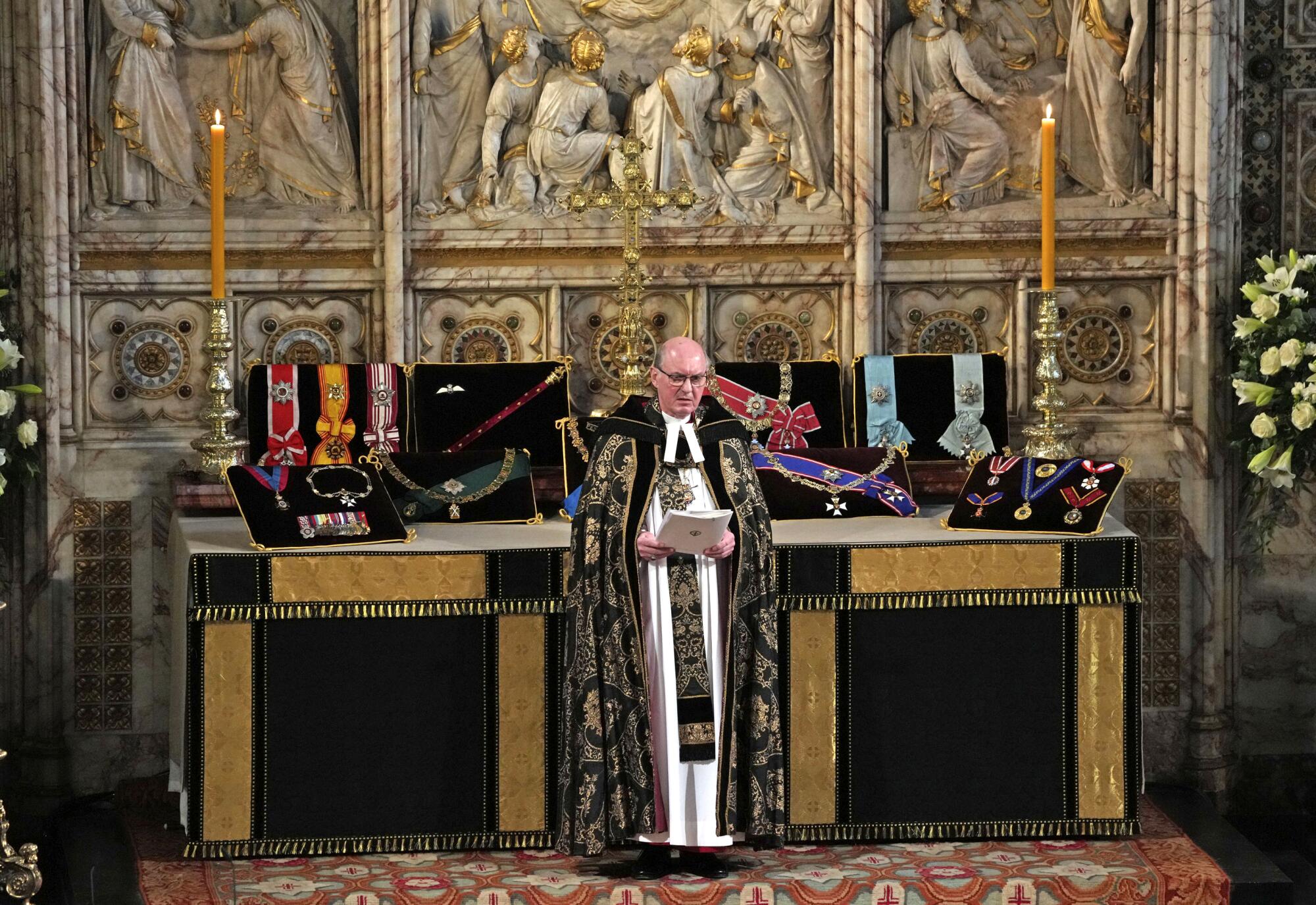 David Conner, Dean of Windsor, stands in front of an altar covered with Prince Philip's insignias.