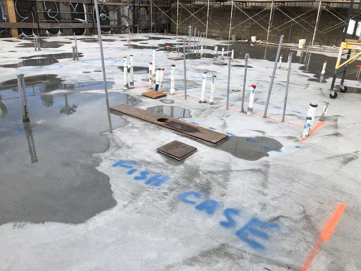 The location of the Crab Cooker's market case is marked on the foundation of the restaurant's new building in Newport Beach