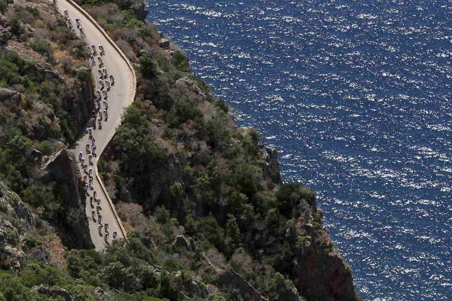 An aerial view shows the pack of riders as they cycle along the coast during the 145,5 km third stage of the centenary Tour de France cycling race from Ajaccio to Calvi