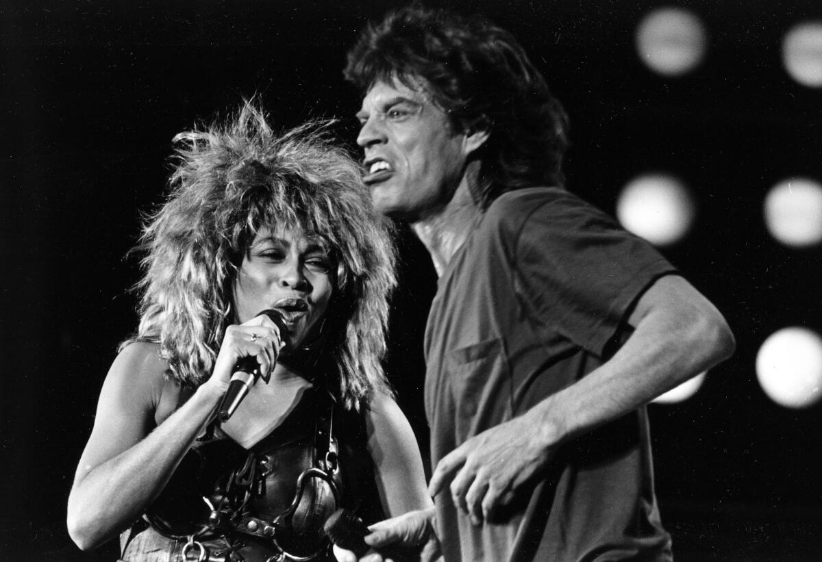 Tina Turner and Mick Jagger sing onstage in Philadelphia in 1985. 