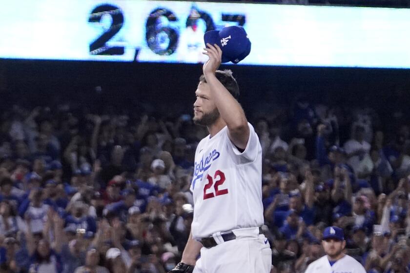 Los Angeles Dodgers starting pitcher Clayton Kershaw acknowledges the crowd after striking.