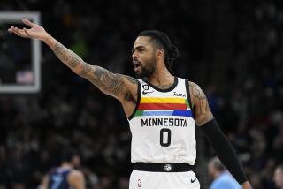 Minnesota Timberwolves guard D'Angelo Russell (0) celebrates after a three-point basket by forward Nathan Knight (13) during the first half of an NBA basketball game against the Memphis Grizzlies, Friday, Jan. 27, 2023, in Minneapolis. (AP Photo/Abbie Parr)