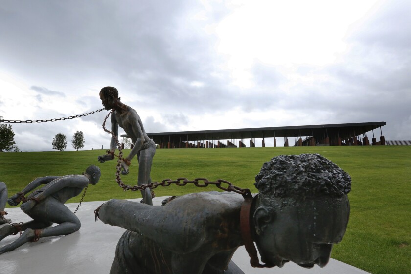 An art piece depicting chained people is displayed at the National Memorial for Peace and Justice in Montgomery, Ala. 