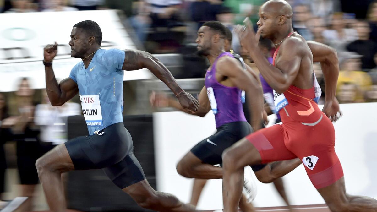 Justin Gatlin pulls ahead of Tyson Gay (purple) and Asafa Powell (red) in the men's 100-meter dash at the IAAF Diamond League meet in Lausanne, Switzerland, on Thursday.