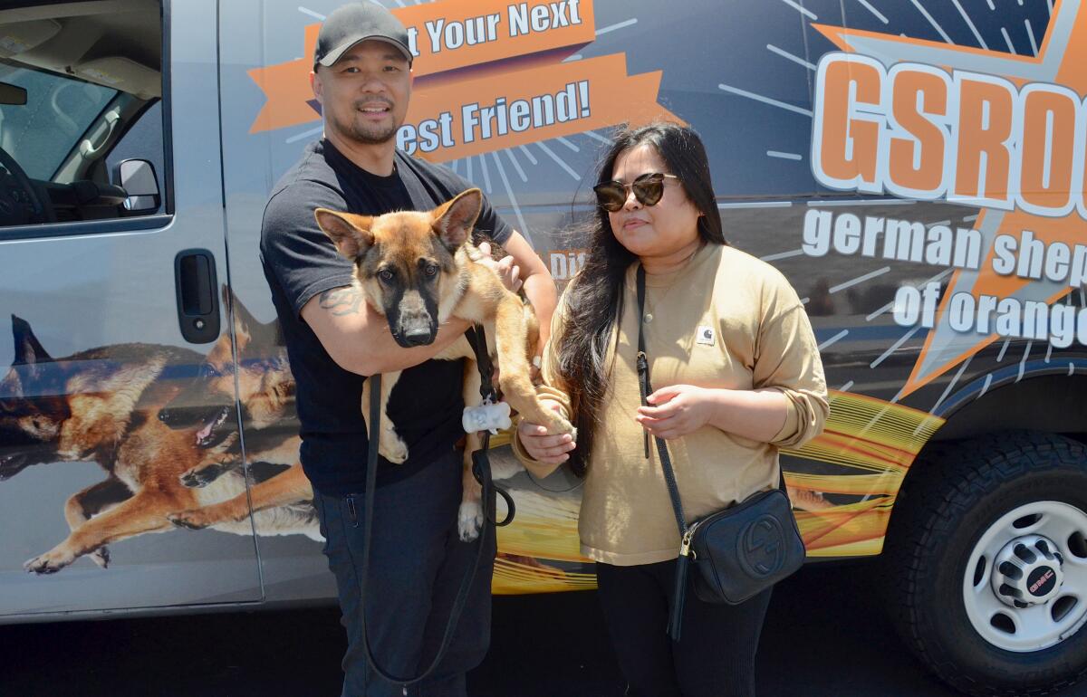 Leo and Pia Bernal pick up Kodie during German Shepherd Rescue Orange County fundraiser in Costa Mesa.
