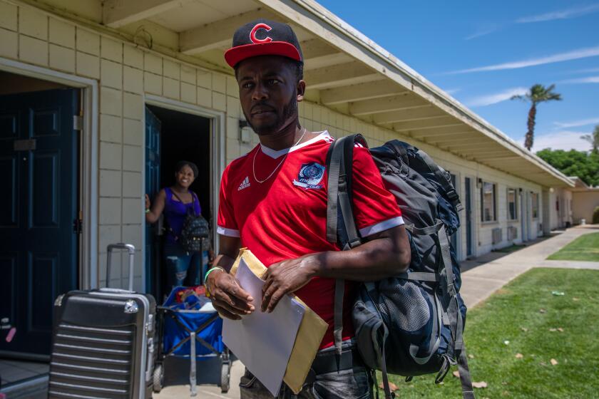 INDIO, CA - MAY 25: Haitian asylum seeker Beginne Moraney, who crossed the border with his wife Sandia Siverre and son Rood Moraney Siverre at an undisclosed motel provided by Galilee center in Indio, CA. (Irfan Khan / Los Angeles Times)
