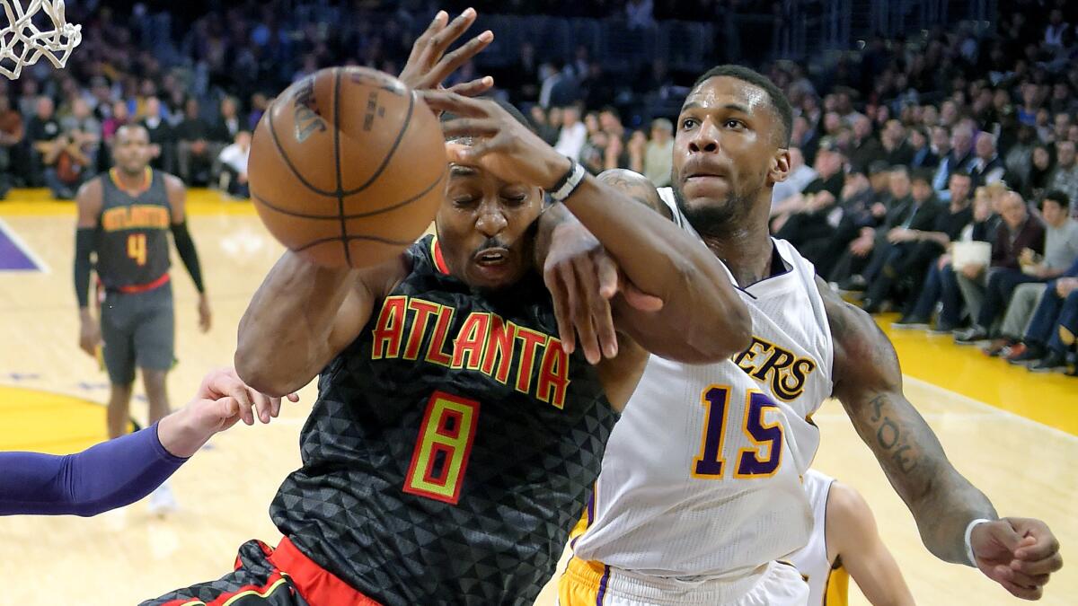 Hawks center Dwight Howard (8) and Lakers forward Thomas Robinson battle for a rebound during the first half Sunday.