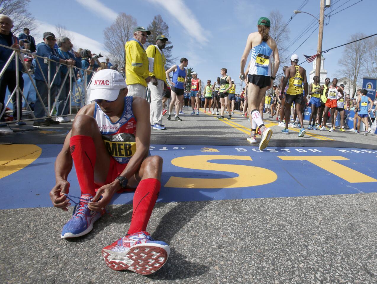 Meb Keflezighi, a Boston Marathon winner, throws out the ceremonial first  pitch before a baseball game between the Boston Red Sox and the Los Angeles  Angels, Friday, April 14, 2023, in Boston. (