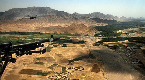 An armed escort chopper trails a Black Hawk medevac helicopter flying to pick up an injured Afghan soldier in Oruzgan province. Patients are flown to a U.S. military clinic at the base in Tarin Kowt, or farther south to a hospital in Kandahar. Armed escorts are necessary to fend of Taliban attacks. A medevac helicopter was shot down June 9 in neighboring Helmand province.