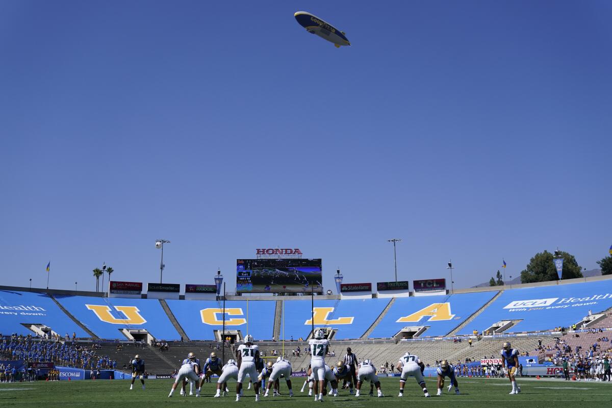 The Goodyear blimp flies above the Rose Bowl as Hawaii plays UCLA.