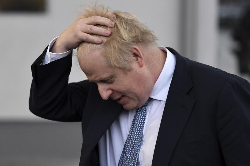 FILE - British Prime Minister Boris Johnson gestures as he speaks to the media during a visit to the Warszawska Brygada Pancerna military base near Warsaw, Poland, Thursday, Feb. 10, 2022. Johnson has received a questionnaire from London’s Metropolitan Police as part of the investigation into parties in Downing Street during COVID lockdowns. Johnson has denied any wrongdoing, but he is alleged to have been at up to six of the 12 events in his office and other government buildings that are being investigated by the police. (Daniel Leal/Pool via AP, File)