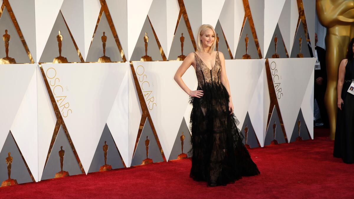 Jennifer Lawrence walks the red carpet at the Dolby Theatre during the Academy Awards this year.
