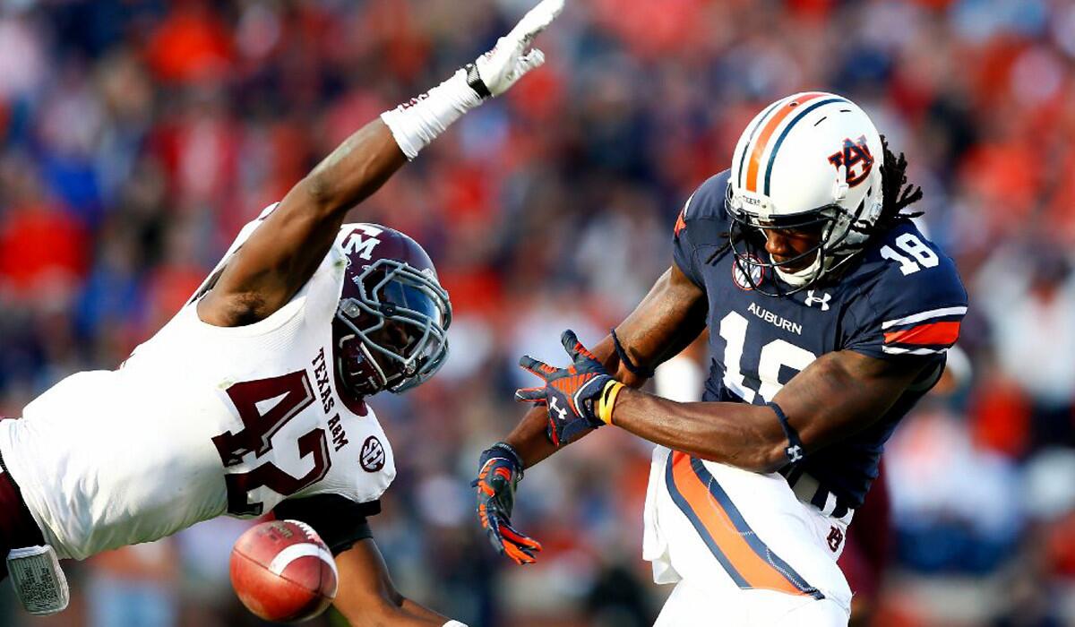 Auburn receiver Sammie Coates can't hang onto a pass that is defended by Texas A&M linebacker Otaro Alaka on Saturday.