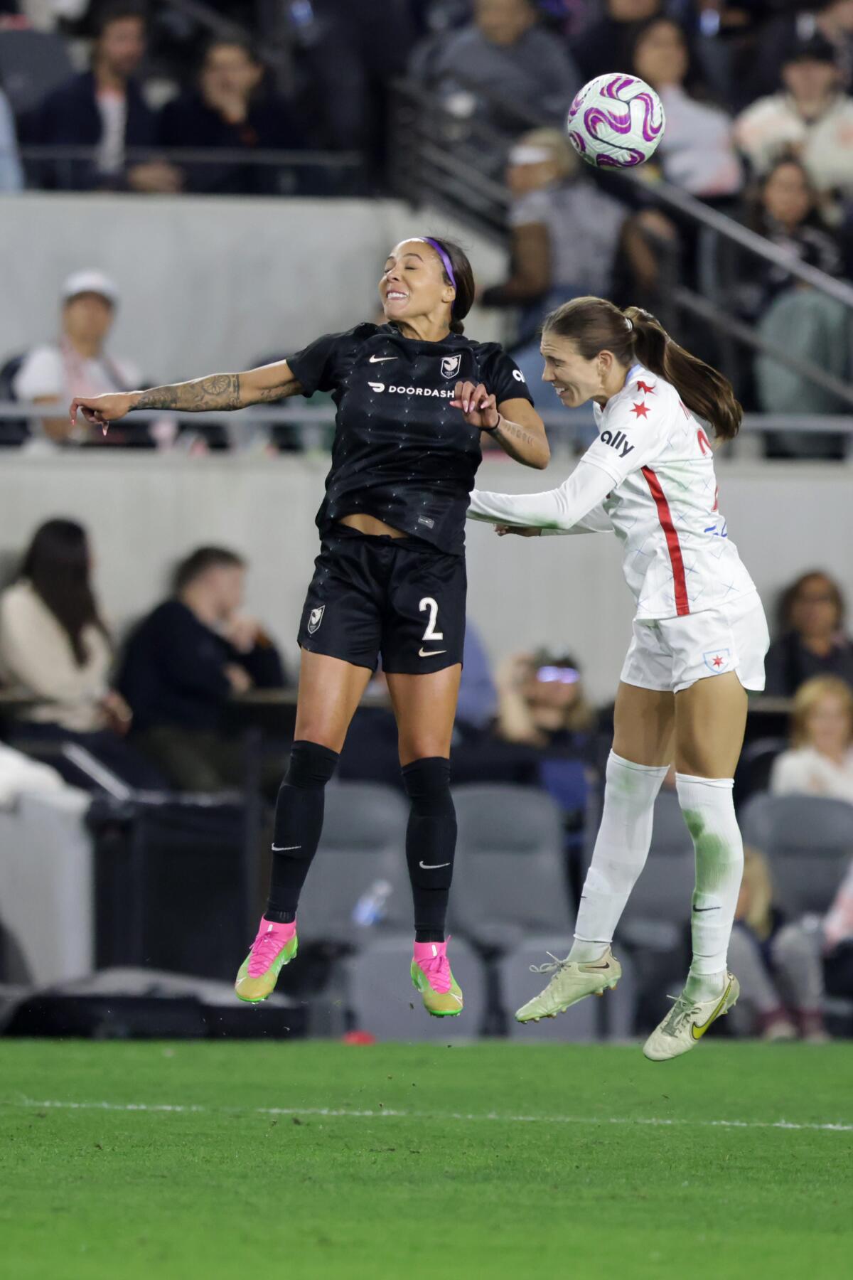 Angel City FC's Sydney Leroux and Chicago Red Stars' Tatumn Milazzo fight for head the ball.