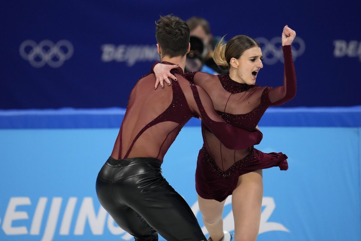 Gabriella Papadakis and Guillaume Cizeron, of France, perform their routine in the ice dance competition during figure skating at the 2022 Winter Olympics, Saturday, Feb. 12, 2022, in Beijing. (AP Photo/Natacha Pisarenko)