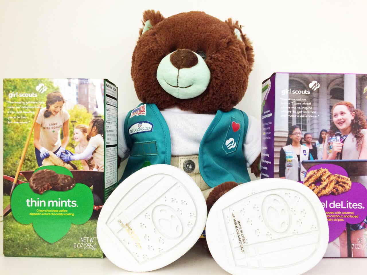 A Grimaldi's Pizzeria in El Segundo is making Girl Scout cookie cheesecake. Pictured is a box of Thin Mints, a box of Caramel deLites (a.k.a. Samoas) and a Girl Scouts bear.