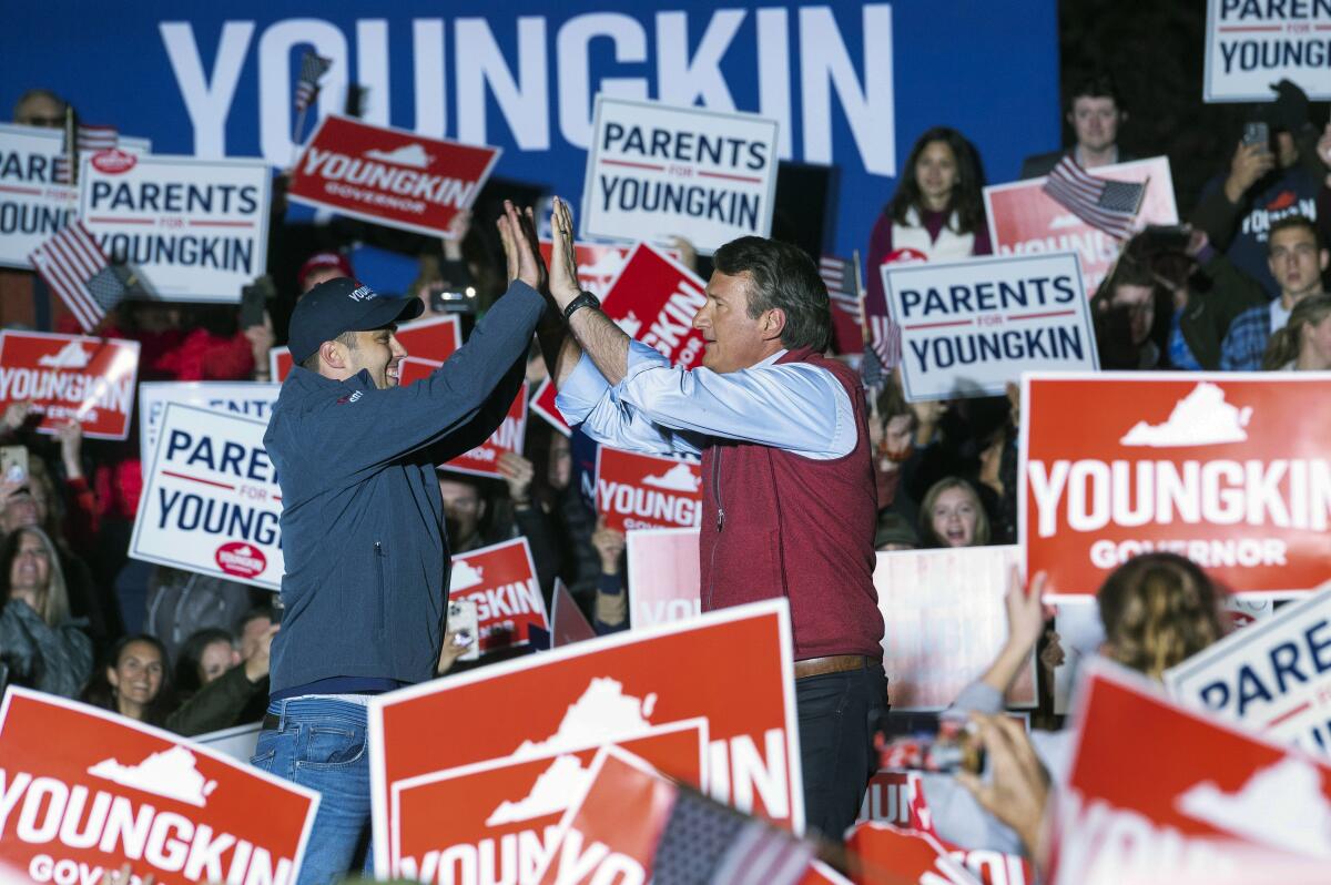 Republican gubernatorial candidate Glenn Youngkin high-fives his son Grant