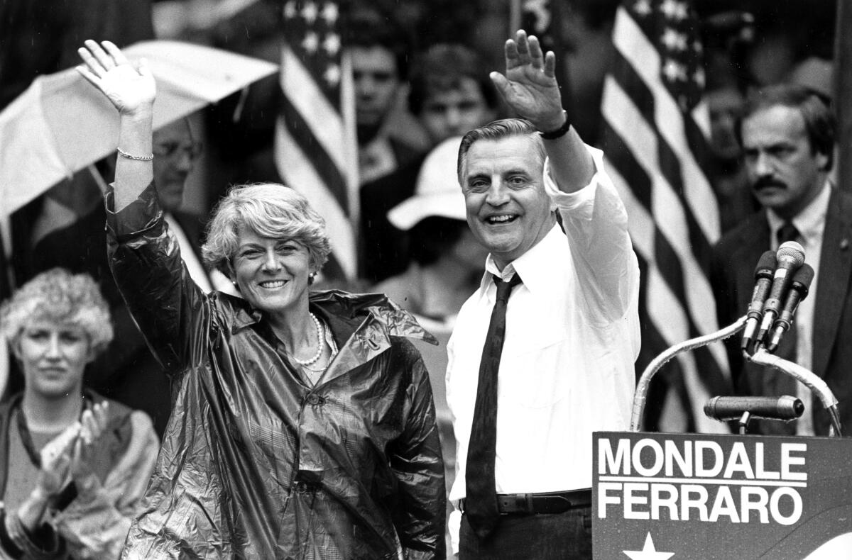 Black-and-white photograph of Walter Mondale, right, with Geraldine Ferraro, both of whom are waving