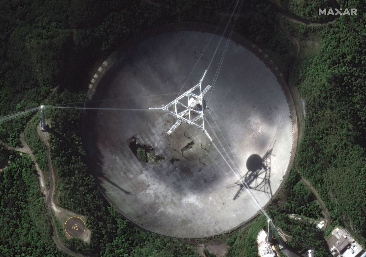 The damaged radio telescope at the Arecibo Observatory in Puerto Rico seen from above. 