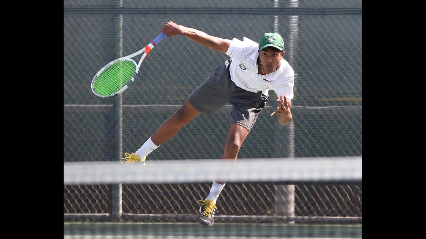 Sage Hill High singles player Rohun Krishna hits a service winner in match against his St. Margaret's opponent in Academy League tennis on Friday.