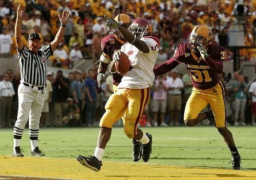 USC tailback Reggie Bush scores the go-ahead touchdown late in the fourth quarter as Arizona State's Josh Barrett, left, and Mike Davis Jr. give chase.