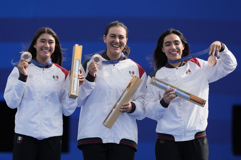 Bronze medal winners, Mexico's Angela Ruiz, left, Alejandra Valencia, center, and Ana Vazquez, right, celebrate during the women's team medal ceremony at the 2024 Summer Olympics, Sunday, July 28, 2024, in Paris, France. (AP Photo/Rebecca Blackwell)