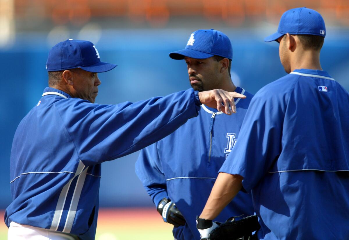 Maury Wills points out a few things to future Dodger manager Dave Roberts in 2003.