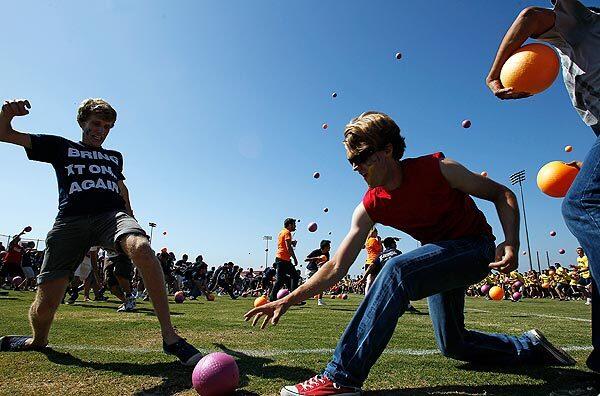 Players participate in what organizers hoped would be a record-setting dodge ball game at UC Irvine. The blue and gold teams each fielded about 2,500 players.