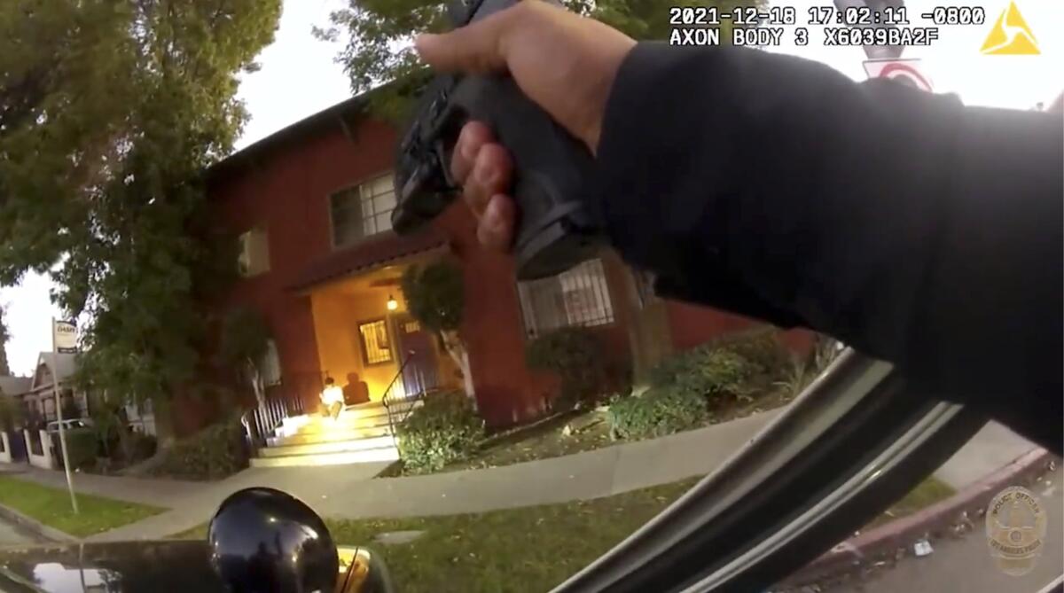 Body camera footage shows a man sitting on steps   as officers arrive  