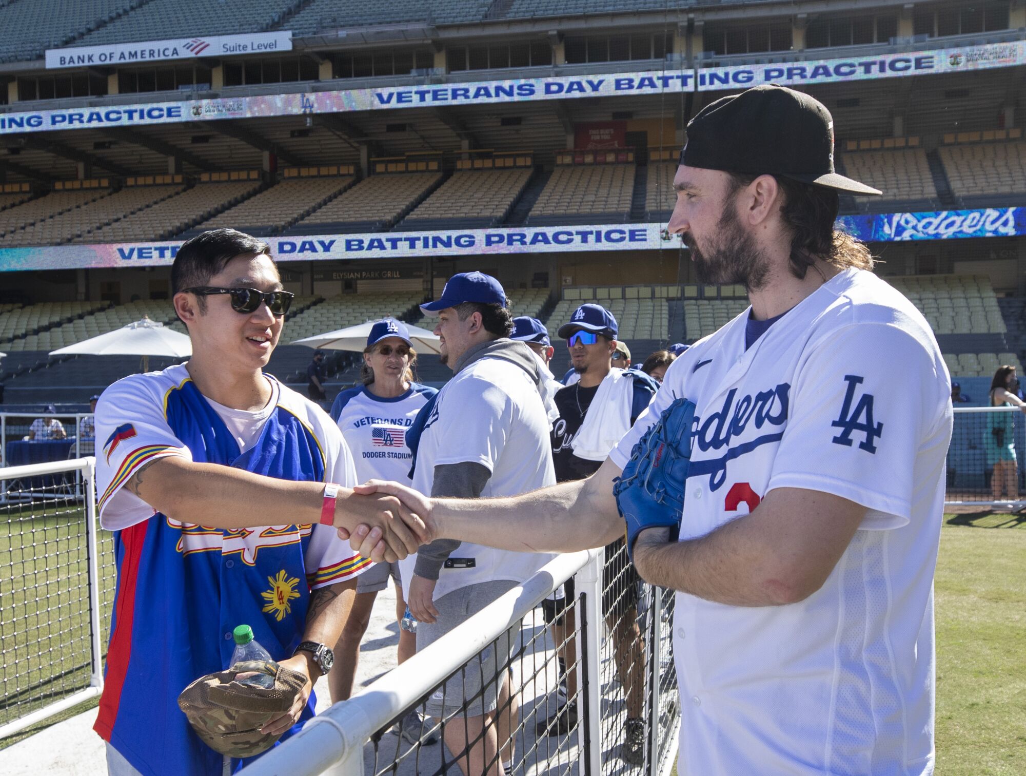A man shakes hands with a Dodgers pitcher