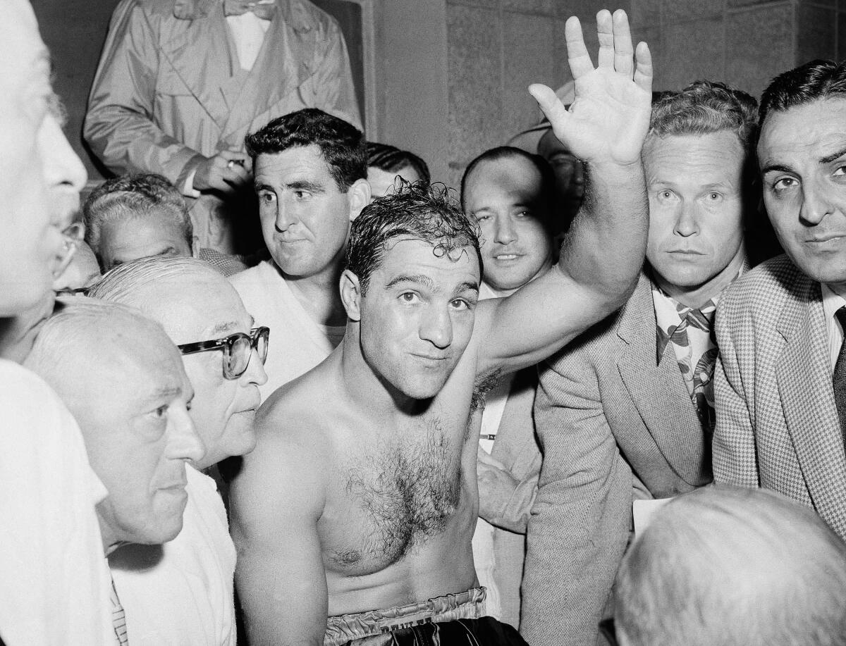 Rocky Marciano celebrates after defeating Ezzard Charles in a heavyweight title bout at Yankee Stadium in June 1954.