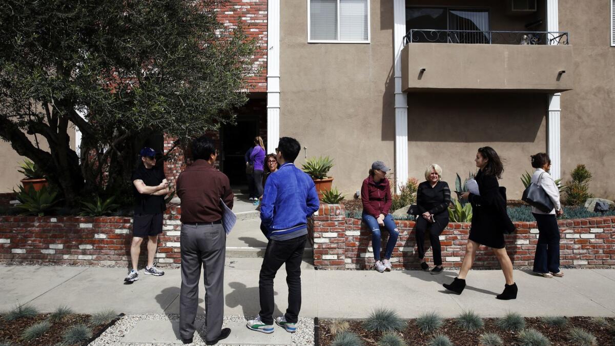 People wait outside to tour a condo during an open house in Los Angeles, Calif. on March 13, 2016.