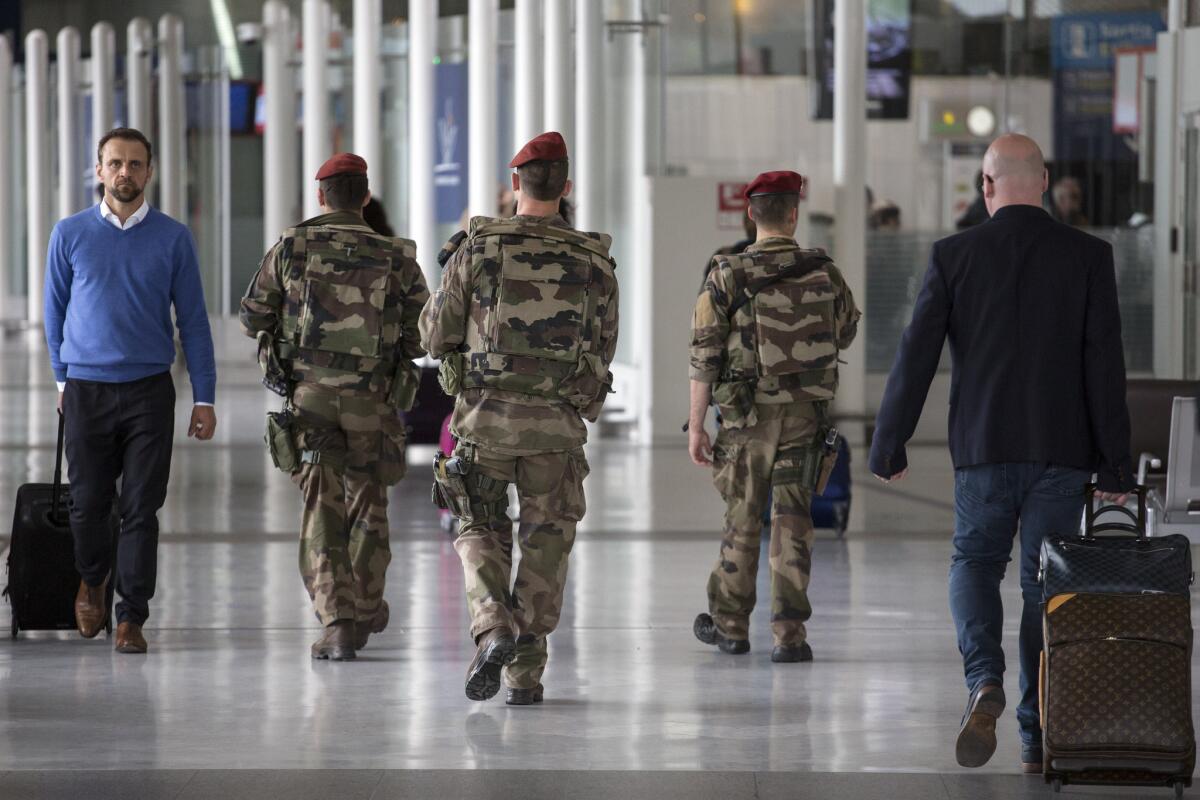 French soldiers patrol at Charles de Gaulle airport on Friday.