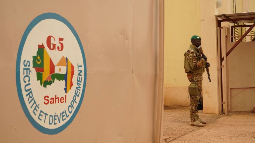 This photo taken on May 30 in Sevare shows a Malian Army soldier standing guard at the entrance of the G5 Sahel, a five-nation anti-terror force. On Friday, the headquarters came under the attack of a suicide bomber.