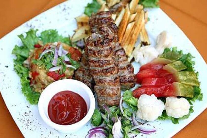 The lulya kebab with French fries, sour watermelon and grilled vegetables at Russian Dacha.
