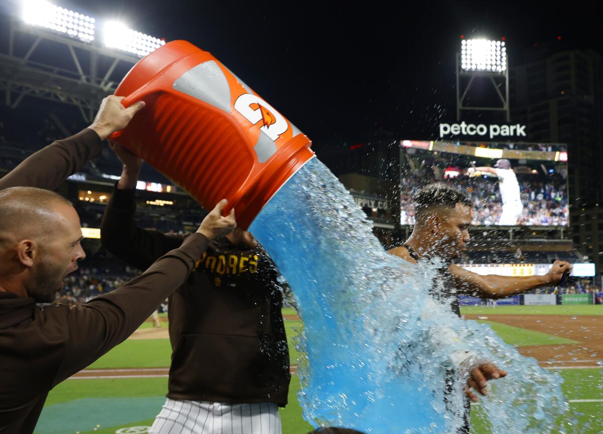 Padres' Xander Bogaerts gets dunked after a walk-off home run.