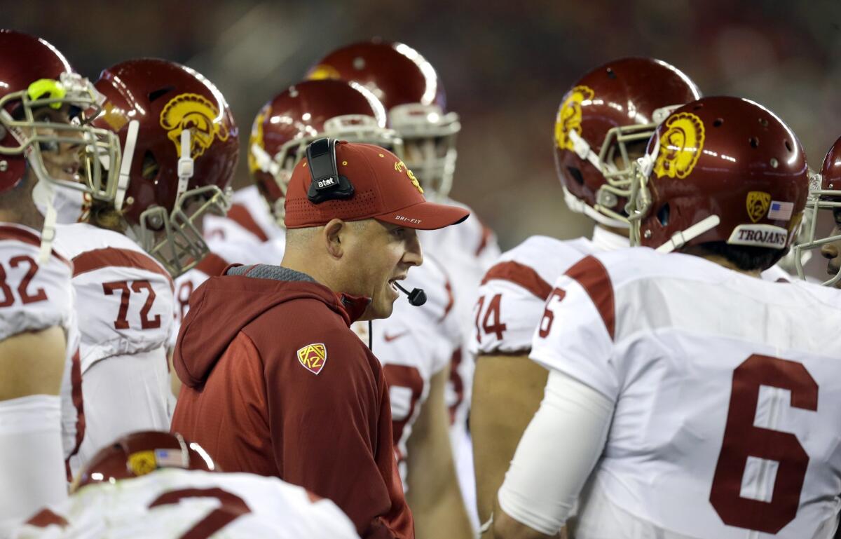 USC Coach Clay Helton speaks with quarterback Cody Kessler (6) during the Pac-12 championship game against Stanford on Dec. 5.