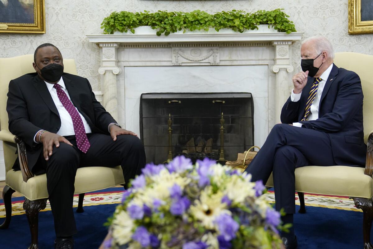 President Joe Biden, right, listens as Kenyan President Uhuru Kenyatta, left, speaks during their meeting in the Oval Office of the White House in Washington, Thursday, Oct. 14, 2021. (AP Photo/Susan Walsh)
