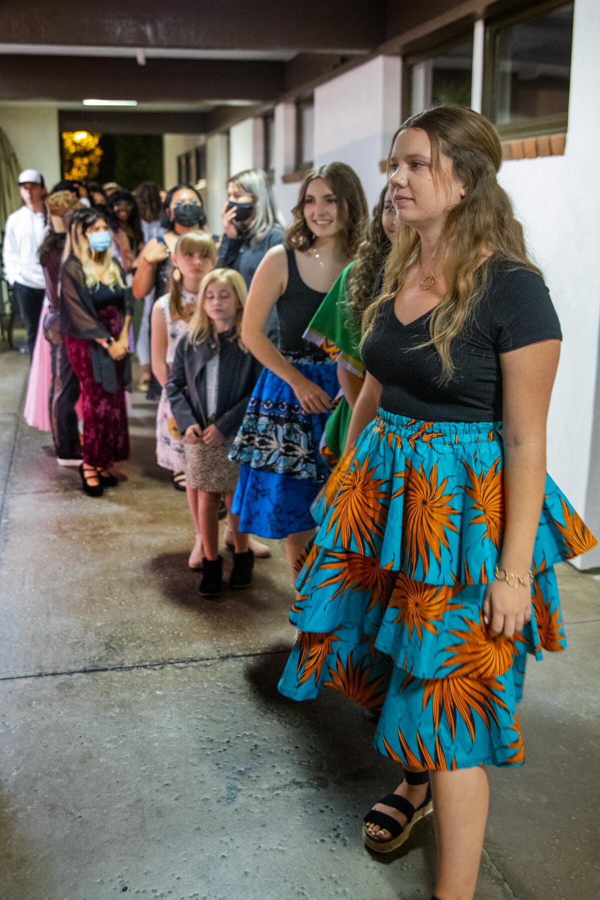 Backstage, models wait to make their entrance on a runway at Vanguard University's Fair Trade Fashion Show. 
