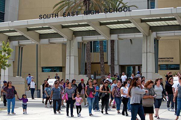 Anxious parents gather at South East High School to get information about the campus stabbing incident. A girl who was wounded in the lunchtime attack later died from her injuries and her boyfriend was held in the incident.