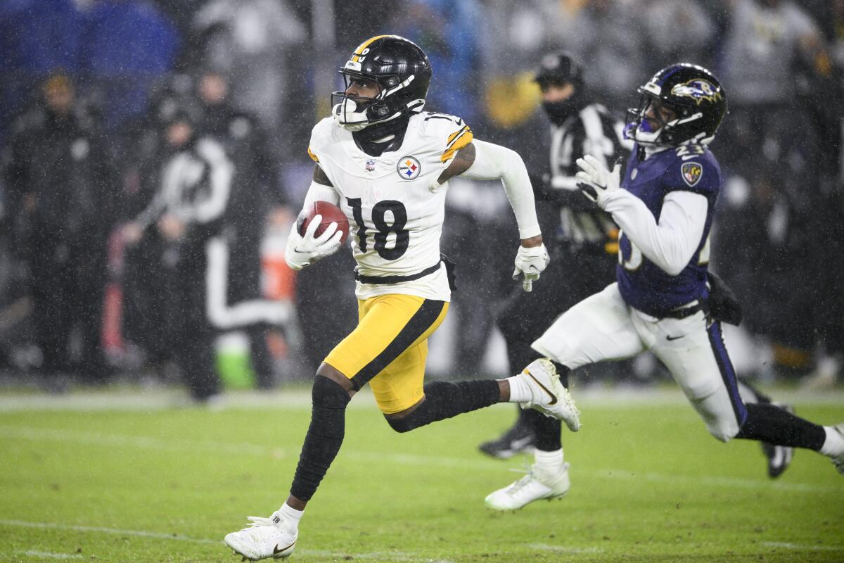 Steelers wide receiver Diontae Johnson, left, outraces Ravens cornerback Rock Ya-Sin on a 71-yard touchdown pass play.