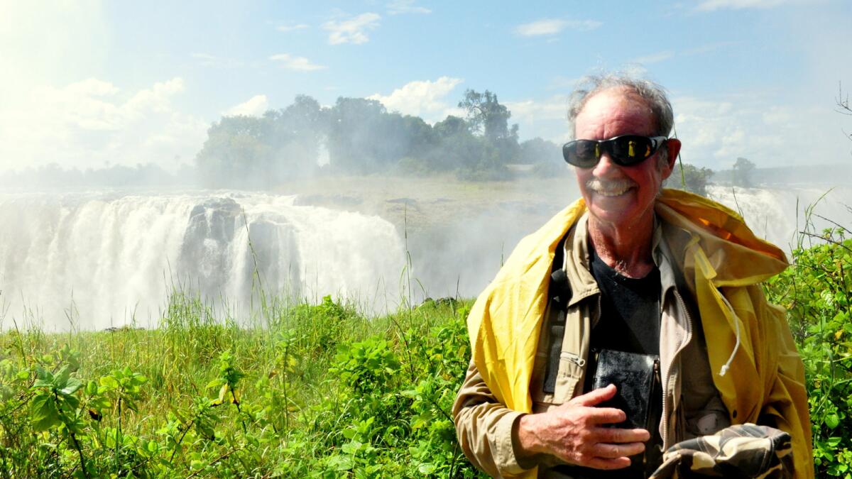 Ian Hirschsohn poses near Victoria Falls in Zimbabwe during one of his yearly trips back to Africa.