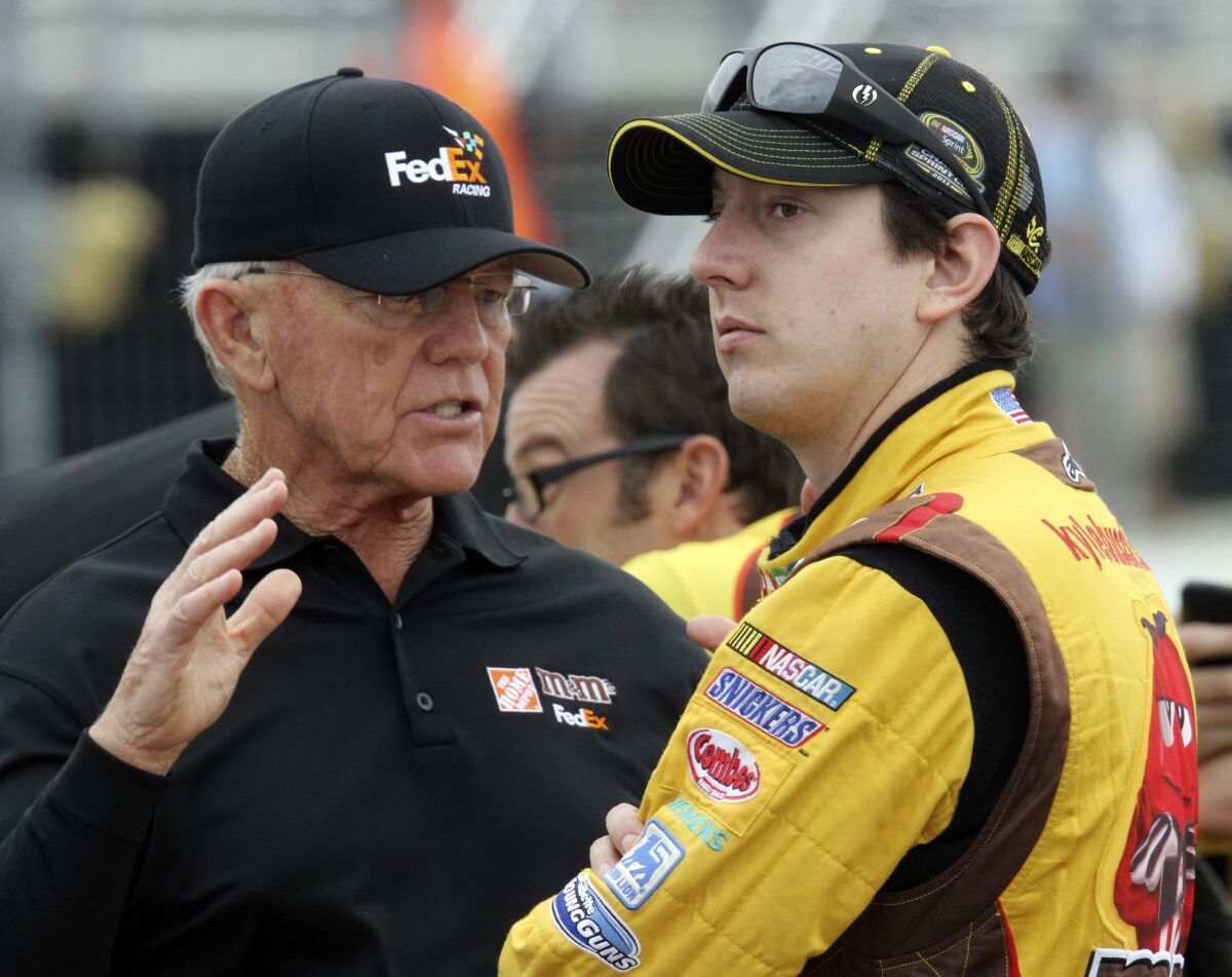 FILE - NASCAR car owner Joe Gibbs, left, talks with his driver Kyle Busch before qualifying for Sunday's Sylvania 300 NASCAR Sprint Cup Series auto race at New Hampshire Motor Speedway, Friday, Sept. 23, 2011, in Loudon, N.H. Team owner Joe Gibbs said 2015 Cup champion Kyle Busch should not have used a slur in a post-race interview and NASCAR was right to order the tempestuous driver to sensitivity training. (AP Photo/Jim Cole, File)